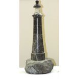 A large Cornish serpentine novelty table lamp in the form of a lighthouse, with transparent glass