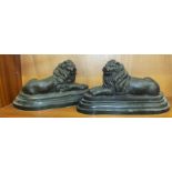 After Barrie, a pair of bronzed metal recumbent lion sculptures on stepped shaped marble bases, 15cm