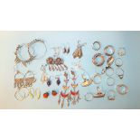 A quantity of 925 silver and white metal earrings and rings, 174g.
