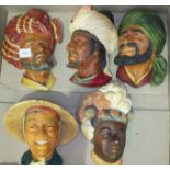 A collection of nineteen Bossons heads, including Punjabi, Saracen, Romanian, Persian, Sardinian,