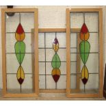 A pair of coloured and clear glass leaded light window panels, 106 x 39cm, a similar panel, 80 x