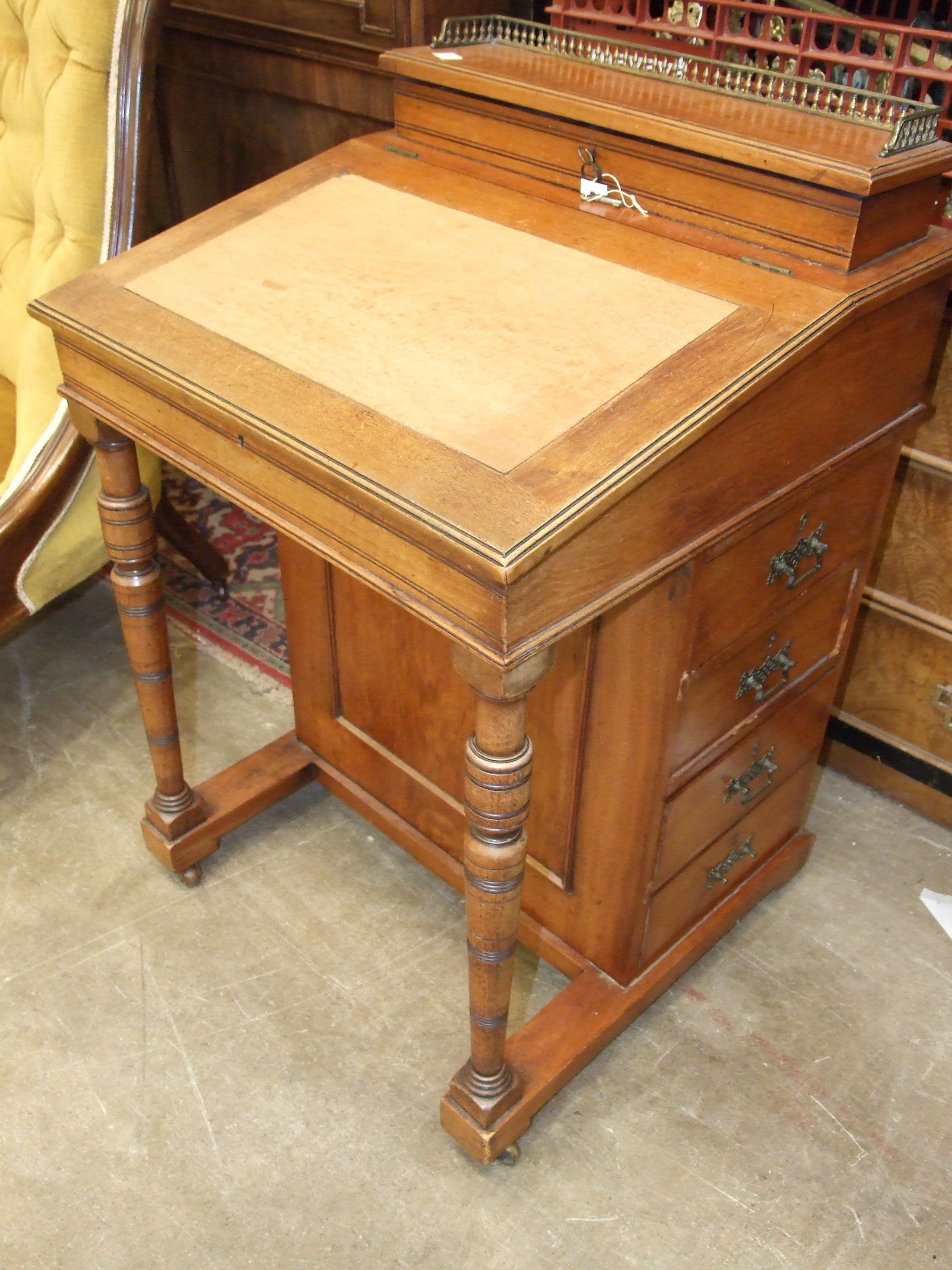A walnut Davenport desk, the top with stationery compartment above four side drawers, 53cm wide, and