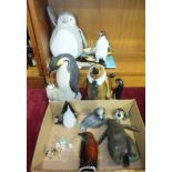 A collection of sixteen wood, glass, ceramic and composite penguin figures, a ceramic tile and a