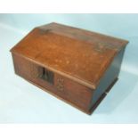 A 17th/18th century oak bible box with sloping hinged top, revealing three small drawers, 64cm wide,