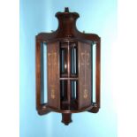 An unusual early-20th century mahogany wall-mounted revolving corner bookcase, with Art Nouveau-