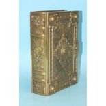 A Victorian novelty brass trinket box in the form of an elaborately-decorated book, with Gothic-