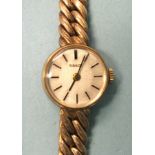 Tissot, a lady's 9ct gold-cased wrist watch on integral 9ct gold tapered double-curb-link