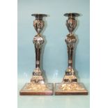 A pair of Old Sheffield plated candlesticks of square tapering form, with urn-shaped capitals,