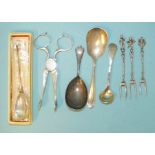 A pair of 18th century silver sugar nips with engraved initials, a reproduction Roman spoon,