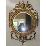 A pair of Victorian Adams-style circular gilt gesso wall mirrors, each bevelled plate with beaded
