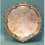 A mid-20th century silver salver of shaped circular form, on three claw and ball feet, with