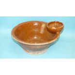 An antique slipware wash bowl, the rim applied with a soap dish, 35cm diameter, 14cm high.