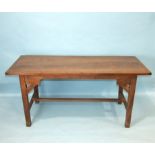 A reconstructed oak farmhouse-style table, the planked top on square tapered legs joined by