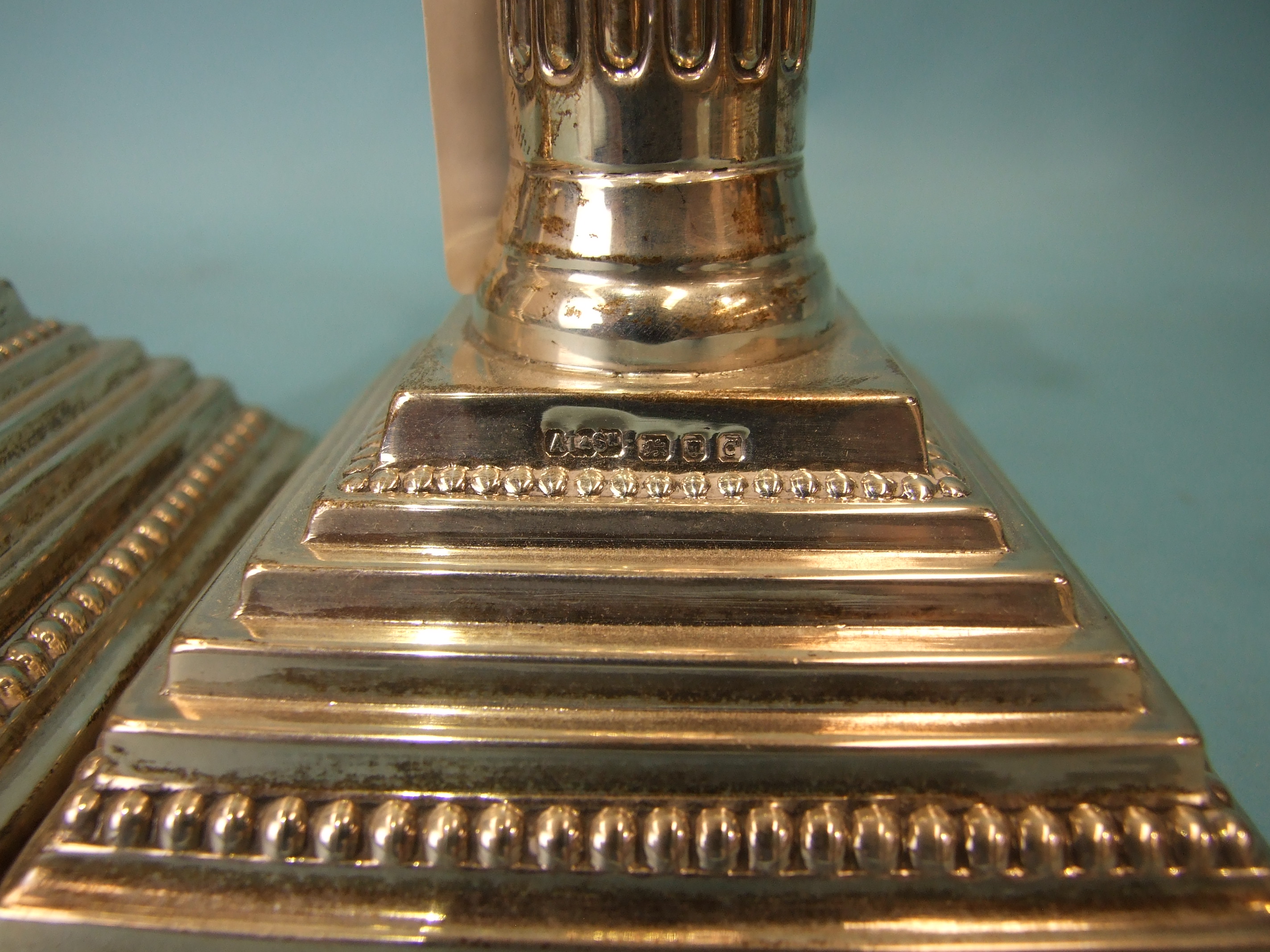 A pair of loaded silver Corinthian column candlesticks on stepped and beaded square bases, with drip - Image 3 of 5