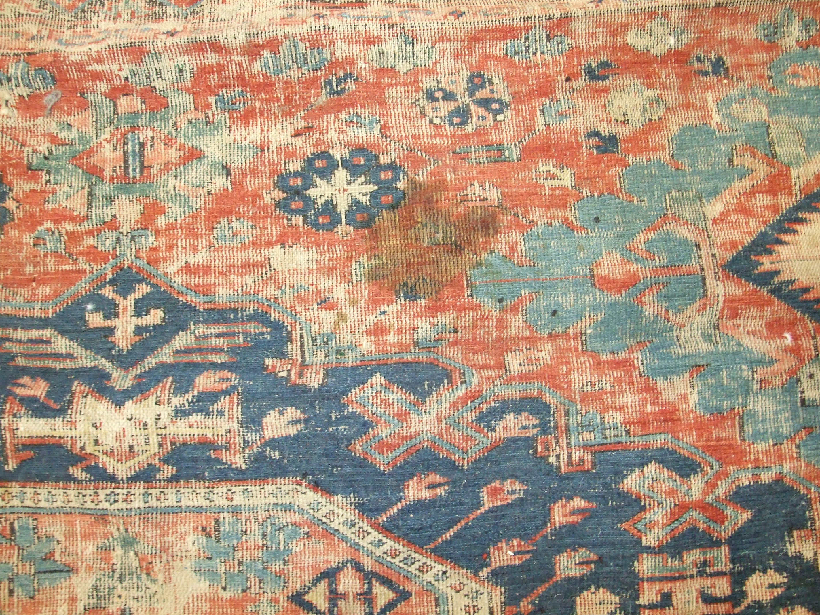 An antique Oriental carpet having four central blue ground lozenges and overall hooked medallions, - Image 3 of 5