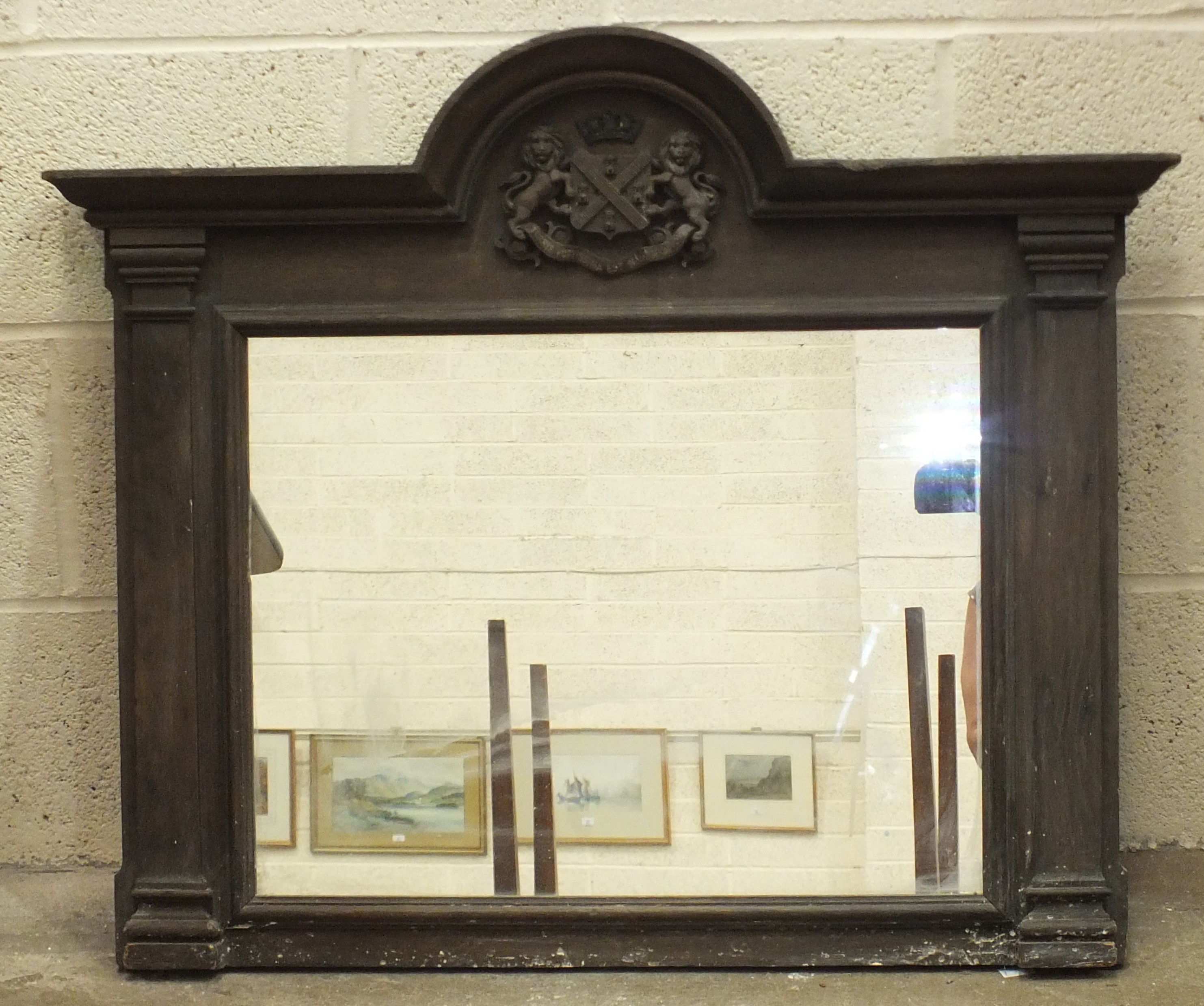 An oak framed mirror, the arched cornice with applied carved Plymouth coat of arms, 87cm wide,