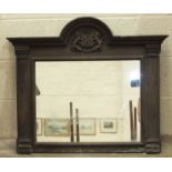 An oak framed mirror, the arched cornice with applied carved Plymouth coat of arms, 87cm wide,