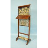 A William IV rosewood screen with rising centre section and small adjustable shelf, on end supports,
