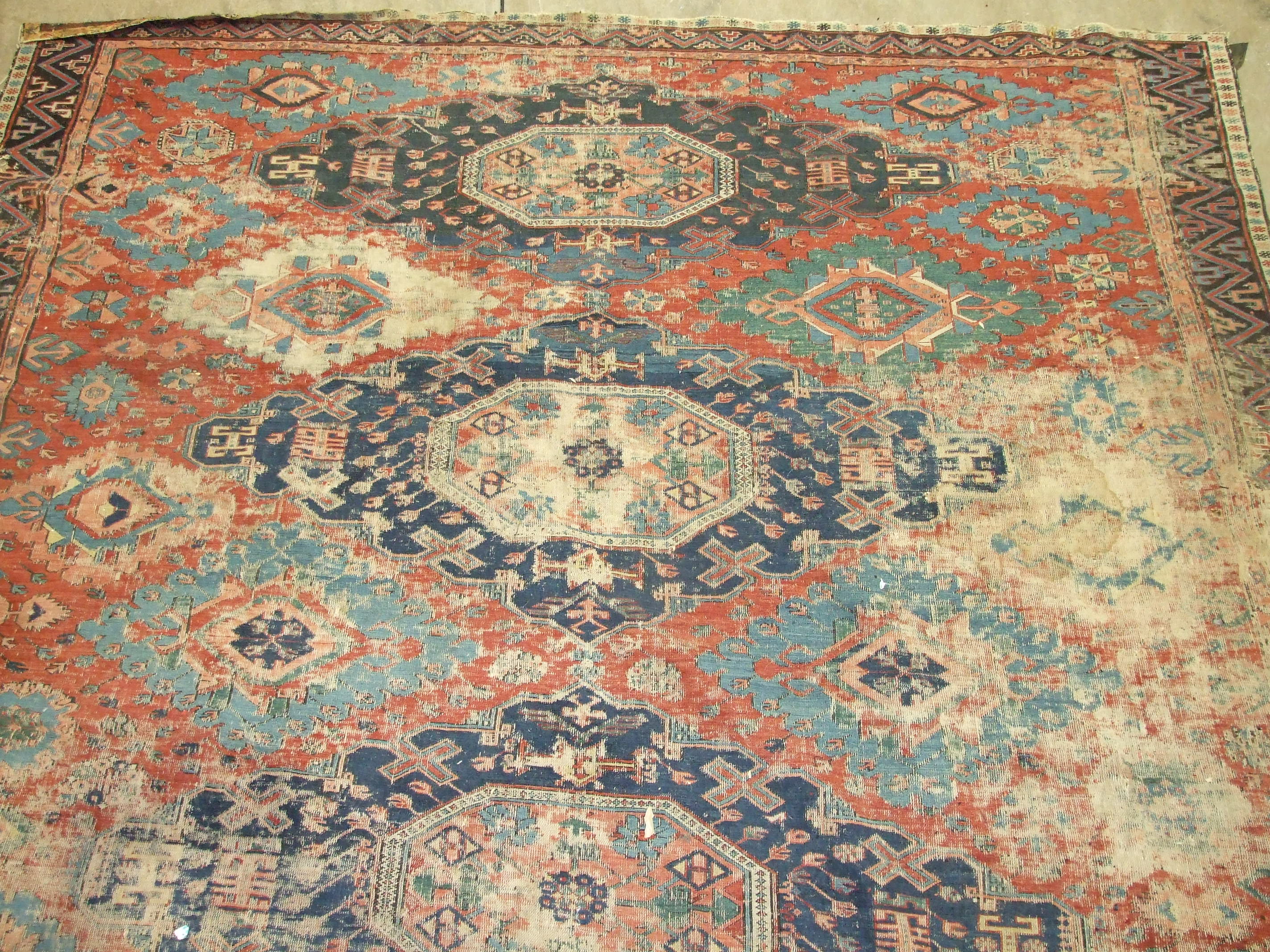 An antique Oriental carpet having four central blue ground lozenges and overall hooked medallions, - Image 2 of 5