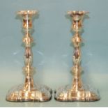 A pair of Georgian-style silver candlesticks on shaped square loaded bases, makers Roberts & Belk,