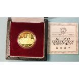 China, a cased 1984 gold proof 100-yuan coin in capsule, with certificate of authenticity.