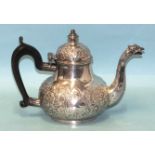 A George III Irish silver teapot of bellied form, embossed with flowers and vacant cartouches, maker