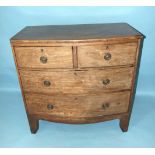 A Georgian mahogany bow-fronted chest of two short and two long cockbeaded drawers, on bracket feet,