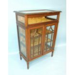 An Edwardian inlaid mahogany bijouterie table and display cabinet, the hinged glazed lid above a