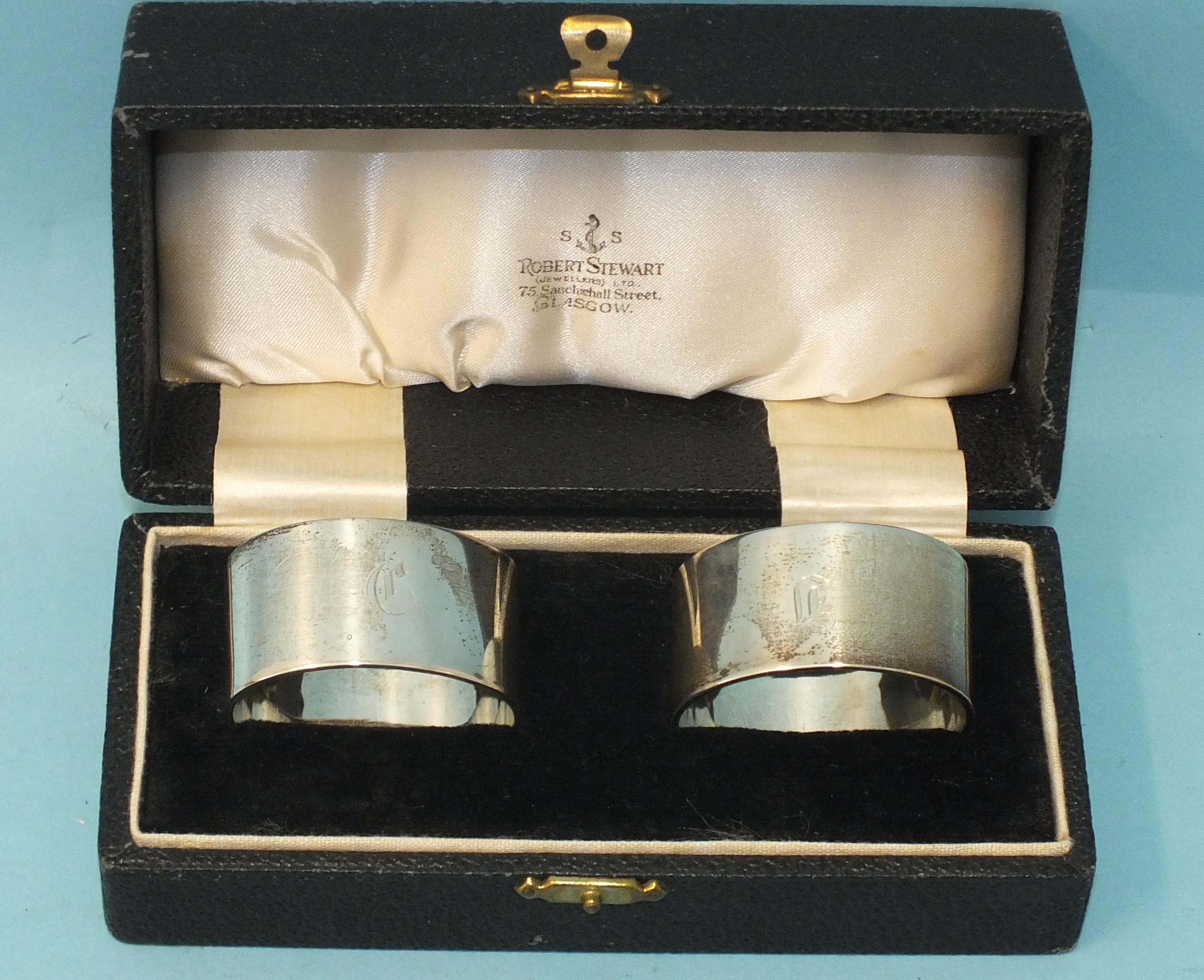 A pair of heavy-gauge oval silver napkin rings, engraved with initials, makers Elkington & Co,