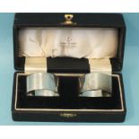 A pair of heavy-gauge oval silver napkin rings, engraved with initials, makers Elkington & Co,
