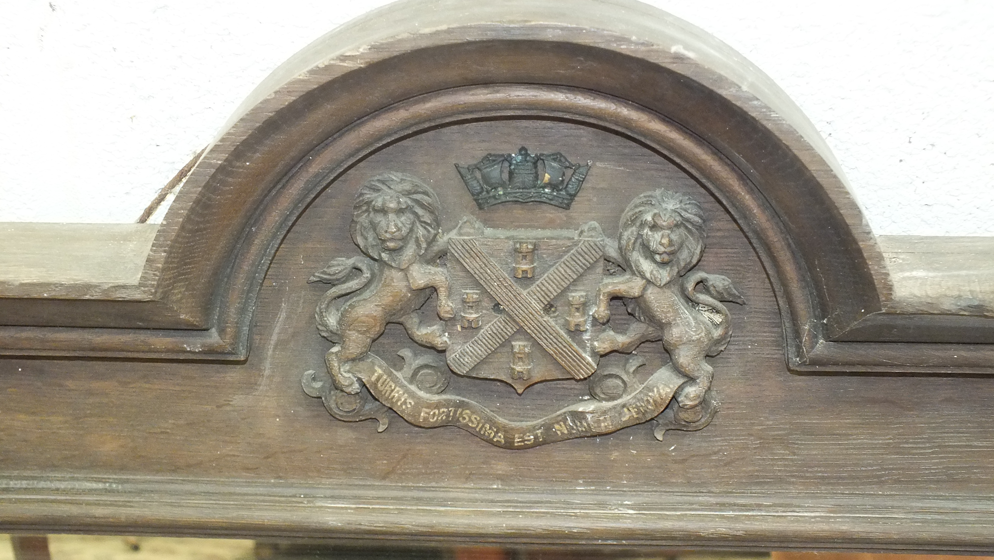 An oak framed mirror, the arched cornice with applied carved Plymouth coat of arms, 87cm wide, - Image 2 of 2