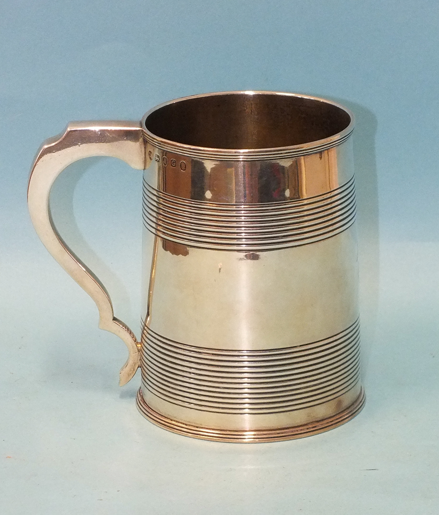 A George III silver tankard of tapered cylindrical form, with reeded bands, monogrammed, maker James