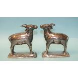 A pair of white metal models of deer, possibly Asian, each standing on a rectangular base, 9.5cm