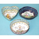 Three French enamelled pin trays: an oval pierced and enamelled dish painted with a courting