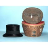 A leather top hat box containing a brushed-silk top hat by Henry Heath Ltd, London, (internal