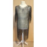 A collection of re-enactment/medieval combat items: a chain mail vest, buckler (foam), shirts, suede