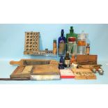 A collection of pill-making equipment, a green "Acid Carbol:l:" bottle, other bottles, scales,