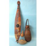 An African gourd drinking vessel with chequered carved decoration and leather-covered studs, 37cm, a