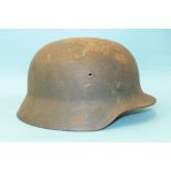 A German M40 steel helmet with indistinct remains of decal, leather liner but no chin strap,