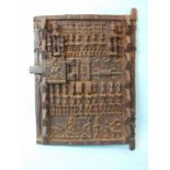 A 20th century carved African Dogon (Mali) granary door, carved with a geometric arrangement of