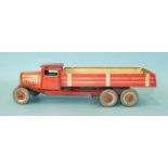 A Mettoy tinplate c/w six-wheel tipper, red and cream, with 'Dunlop 90' balloon tyres, 32cm long.