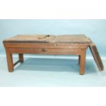 An early-19th century oak-framed medical examination couch, with mechanical action and winding