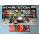 An Atari video computer system, model no. CX-2600, boxed with instructions and two games, 27 '