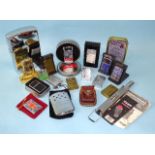 A collection of eight Zippo lighters of plain or engraved decoration, a large chromium-plated