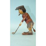 A wooden toy in the form of a golfer teeing off, the figure twisting from the waist, constructed