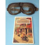 A pair of vintage motorcycle goggles and a book of repro classic motorbike postcards.