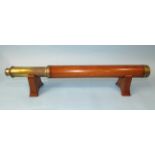 A brass and wooden single-draw telescope, 50cm closed, (splits to wooden casing).