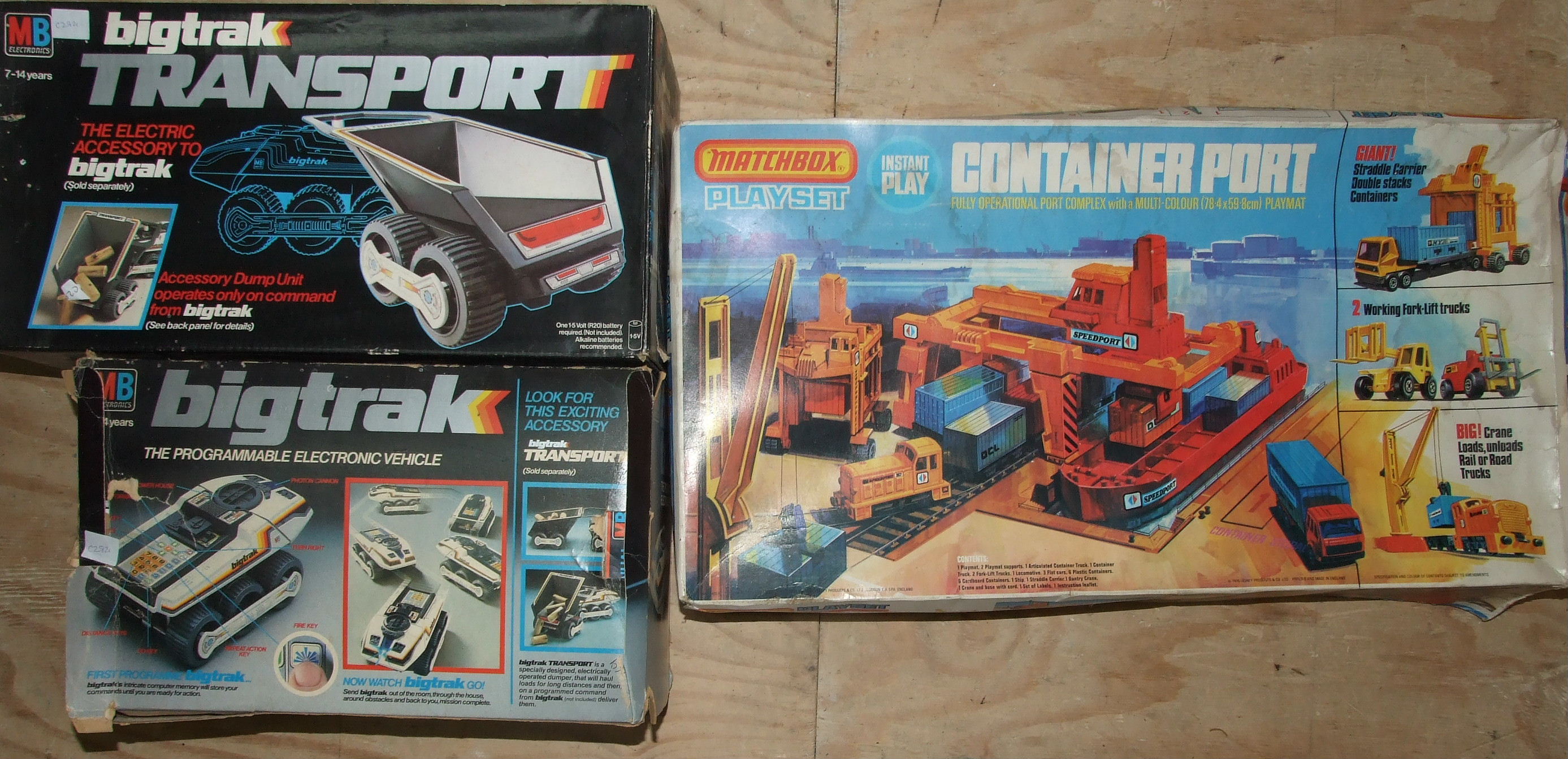Big Trak Programmable Electronic Vehicle and Big Trak Transport, both boxed and a Matchbox Container