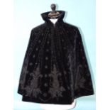 A 19th century French short cape of black velvet, decorated with satin appliqué and black glass