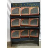 Huntley & Palmers, a set of three grocers metal shelves holding nine Huntley & Palmers glass-